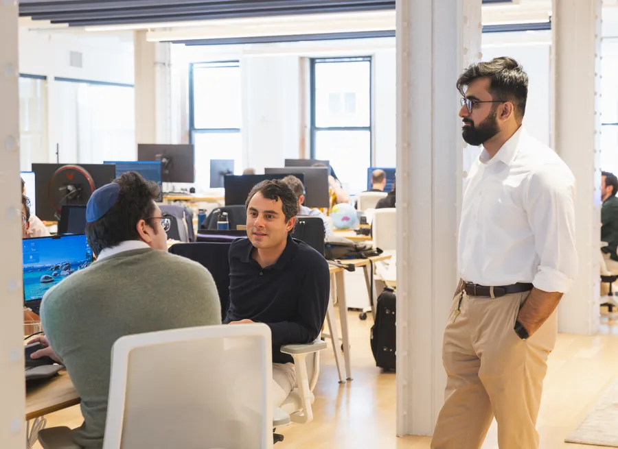 Colleagues chatting near the desks